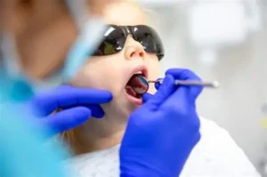 Dentist explaining cavity prevention tips for kids at Ivory Dental World