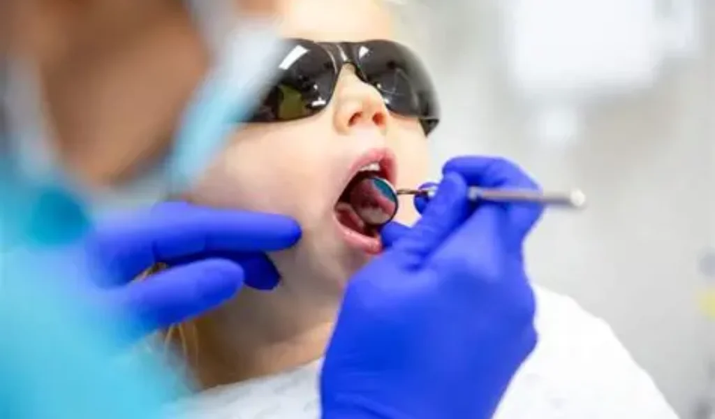 Dentist explaining cavity prevention tips for kids at Ivory Dental World